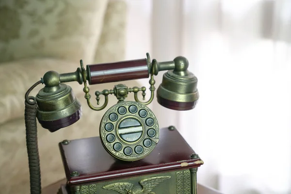 Classic vintage phone on a wooden top — Stok fotoğraf