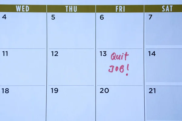 Quit job words written on table calendar with red marker. Employment or careers concept.