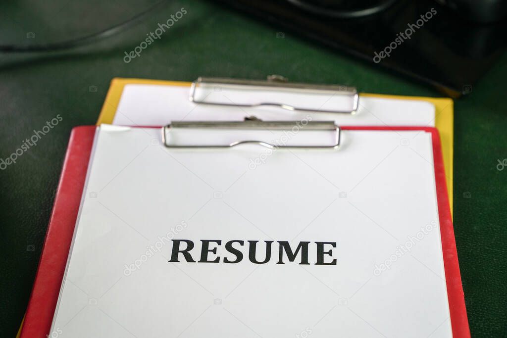 Closeup of resume on clipboard on top  of office table