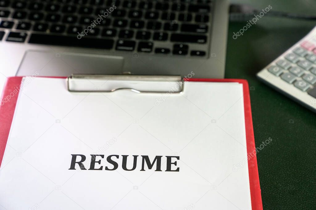 Closeup of resume on top of computer laptop on table