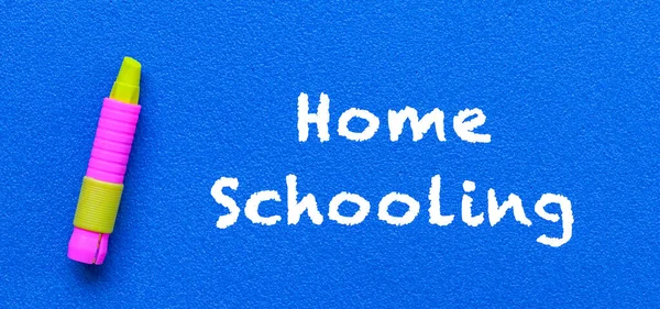 Homeschool. Words or typed text on blue board. wiht a yellow crayon. Education concept.