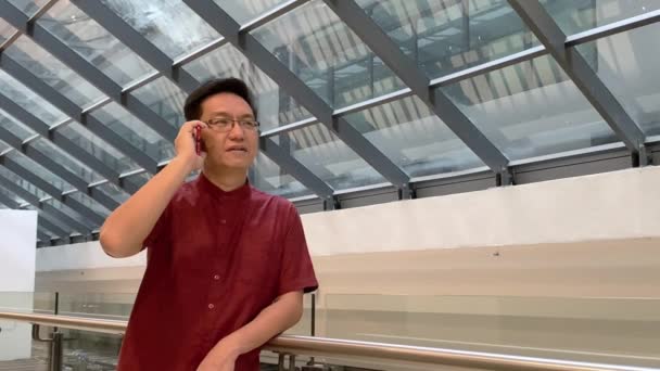 Asiatisk Kinesisk Affärsman Pratar Sin Mobil Bakgrund Till Kontorsbyggnaden — Stockvideo