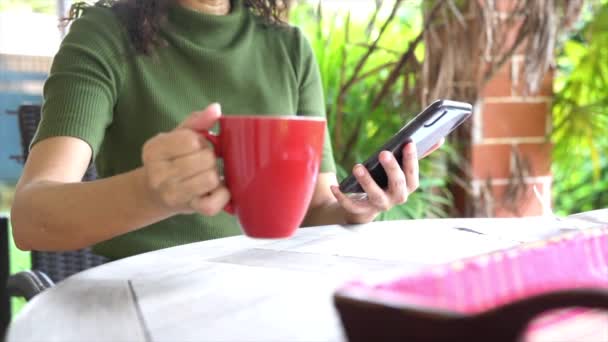 Vrouw Drinken Van Haar Koffie Rode Beker Tijdens Het Surfen — Stockvideo