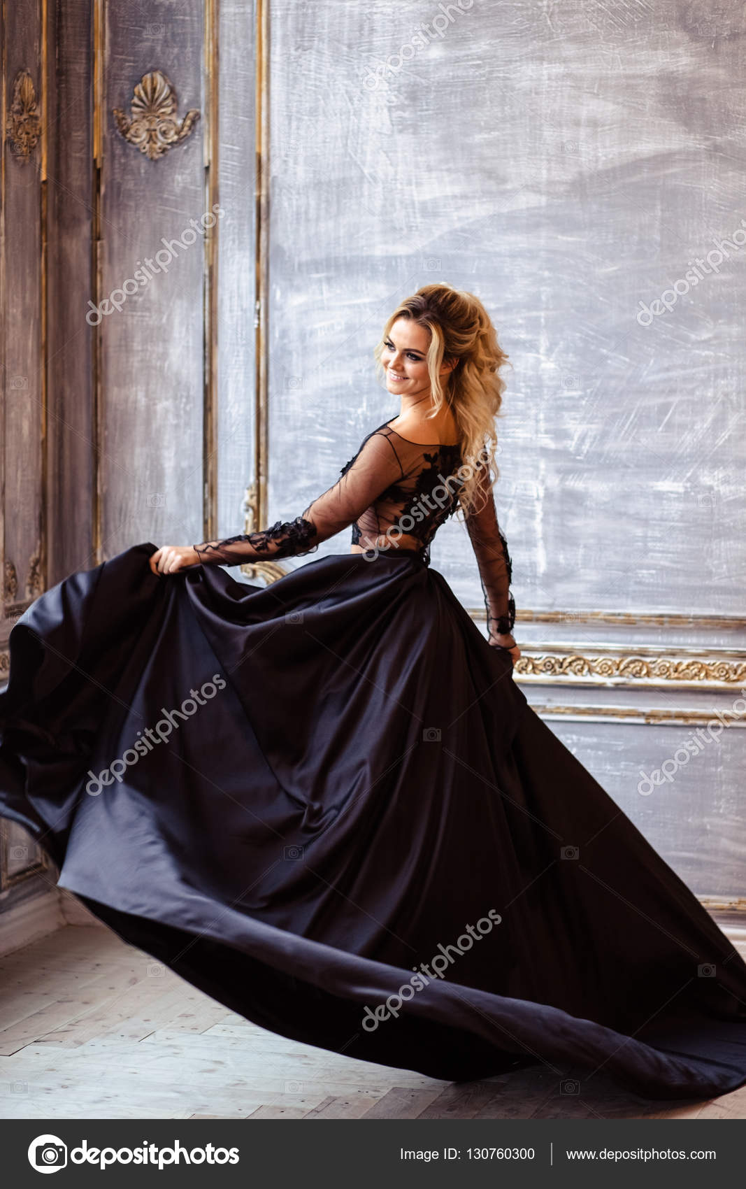 Beautiful young woman in gorgeous black evening dress with perfect makeup  and hair style Stock Photo by ©cherry_daria 130759996