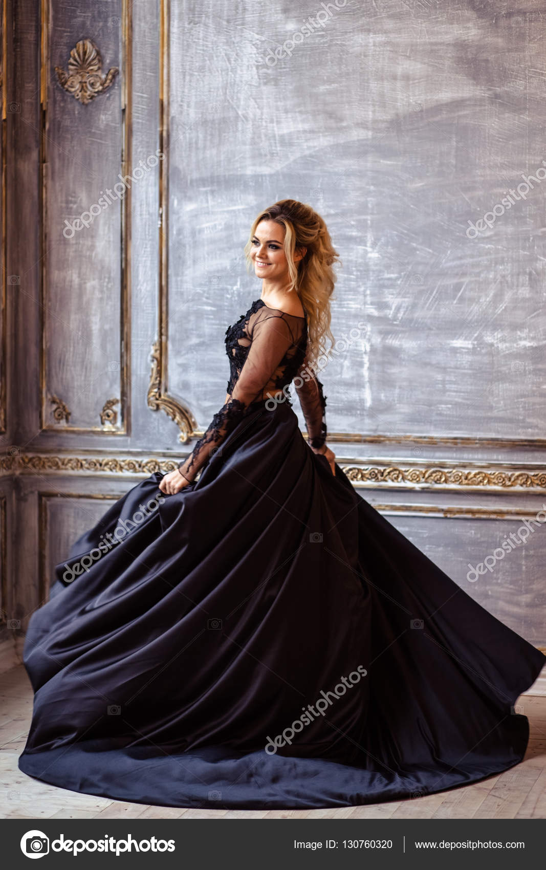 Beautiful young woman in gorgeous black evening dress with perfect makeup  and hair style Stock Photo by ©cherry_daria 130760320