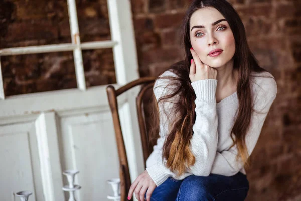 Close-up portrait of beautiful young woman in casual clothes in a loft interior — Stock Photo, Image