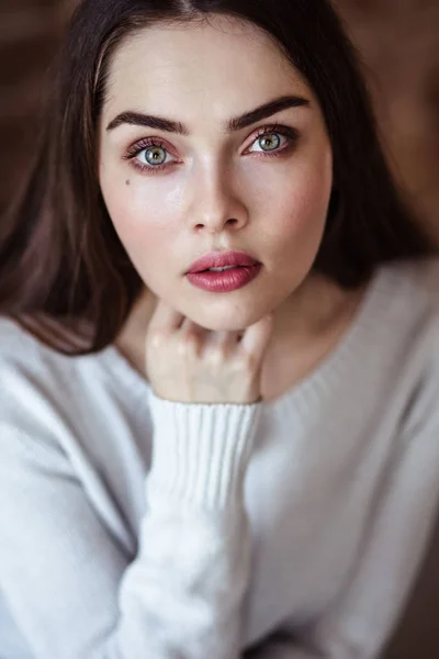 Close-up portrait of beautiful young woman in casual clothes in a loft interior — Stock Photo, Image