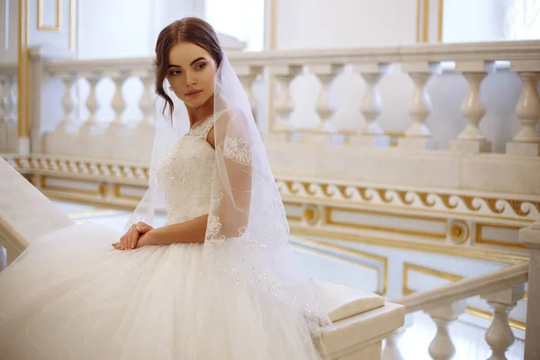 Bella giovane donna sposa in abito da sposa di lusso in interni — Foto Stock