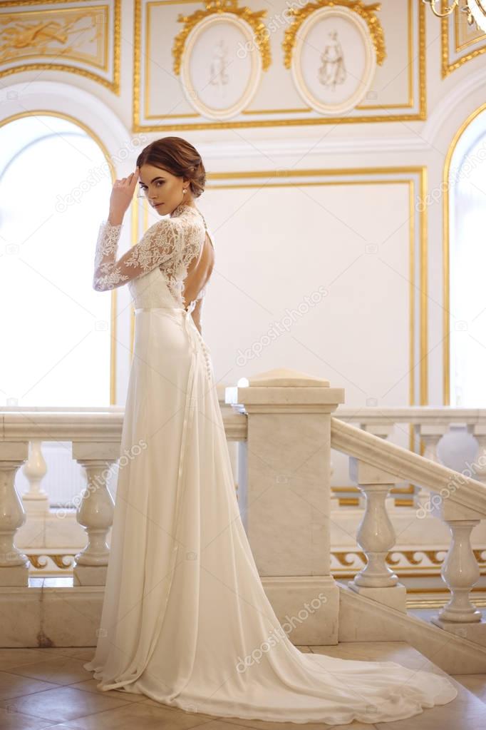 beautiful young woman bride in luxury wedding dress in interior