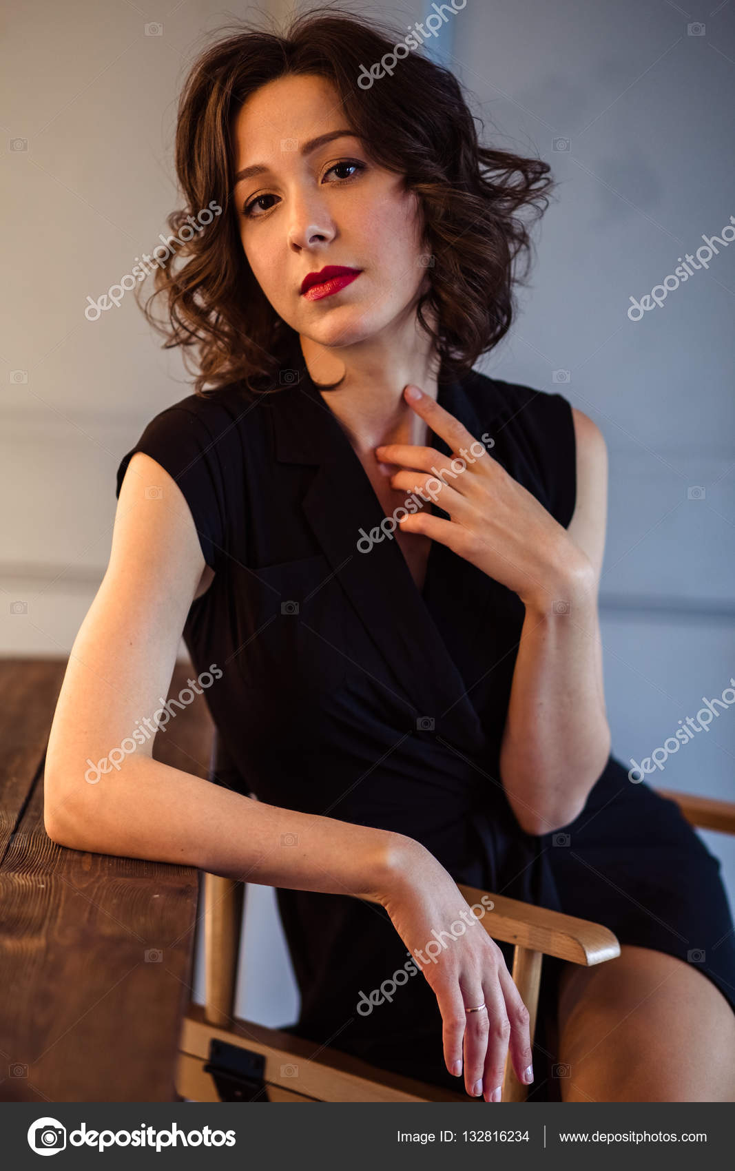 Tender Young Woman In A Black Dress With Natural Makeup And