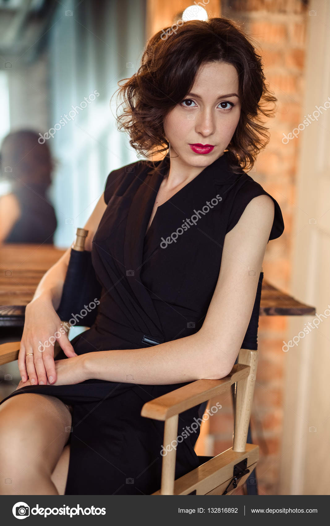 Tender Young Woman In A Black Dress With Natural Makeup And