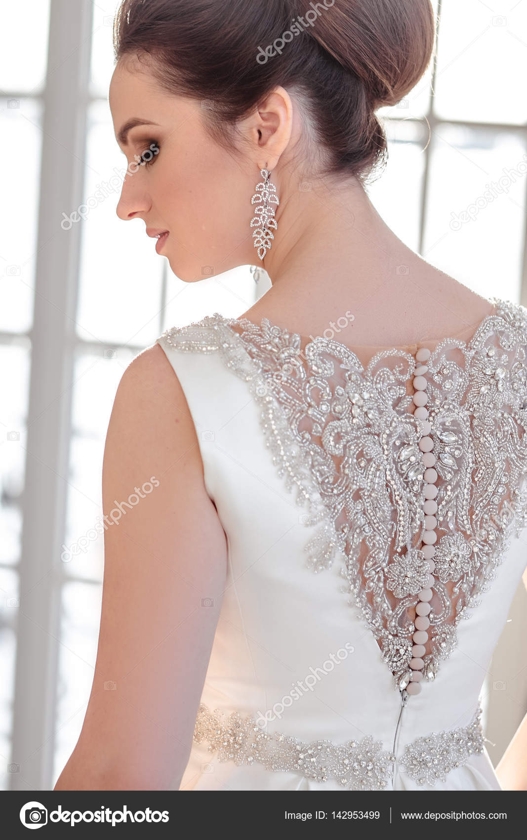 portrait of beautiful brunette bride with elegant hairstyle and makeup  wearing long luxury wedding dress Stock Photo | Adobe Stock