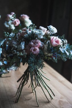 Çiçekçi işyeri: çiçek ve aksesuarları bir vintage ahşap masa üzerinde. yumuşak odak. Bir tabloda basit kompozisyon bir vazoda modern buket