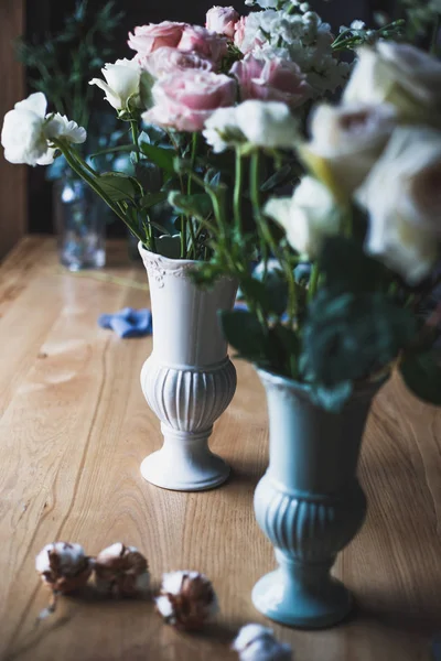 Florist workplace: flowers and accessories on a vintage wooden table. soft focus