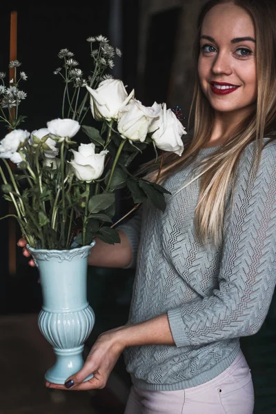 Florista en el trabajo: mujer rubia bastante joven sostiene ramo moderno de moda de diferentes flores — Foto de Stock