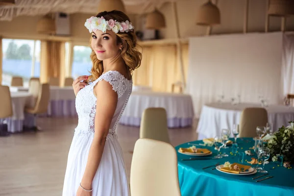 Sexy jovem noiva loira em um vestido branco de casamento de cruzeiro em um restaurante do mar de verão — Fotografia de Stock