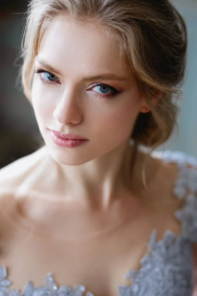 Young blonde bride woman in a light blue wedding dress, fashion beauty portrait in interior — Stock Photo, Image