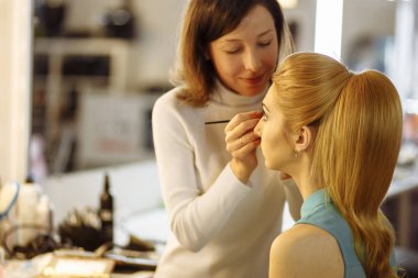 Makyöz photosession önce soyunma odasında modeli hazırlama