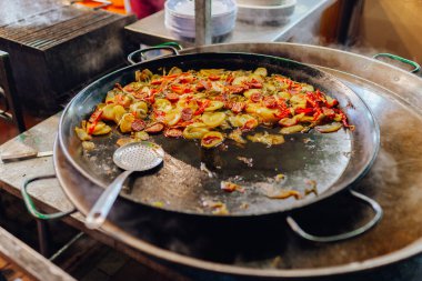Sosisli ve sebzeli kızarmış patates, dilimler halinde dilimlenmiş ve yağda kızartılmış, köy usulü. Kızarmış patates ve sosis kızartma tavasında. İspanyol gıda konsepti.