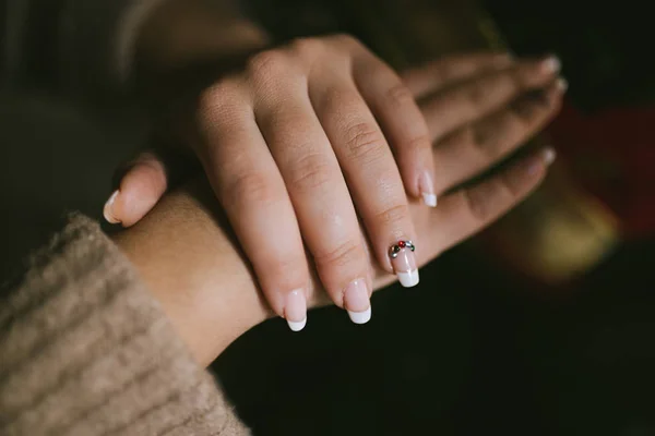 Elegancka i długotrwała kobieta francuski manicure z kolorowymi koralikami. Dama z francuskim manicure. Piękne żeńskie paznokcie. Pojęcie kobiecości i piękna — Zdjęcie stockowe