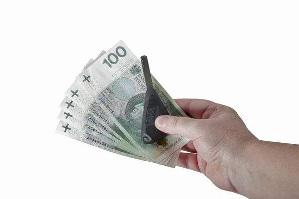Hand holding polish zloty bills and car keys isolated — Stock Photo, Image