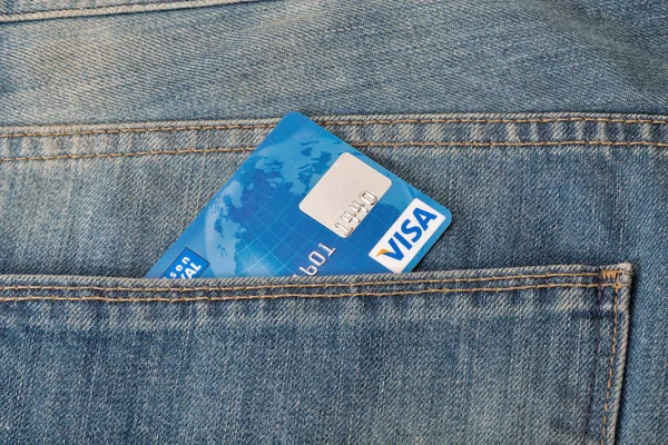 Visa credit card in pocket of blue jeans closeup — Stock Photo, Image