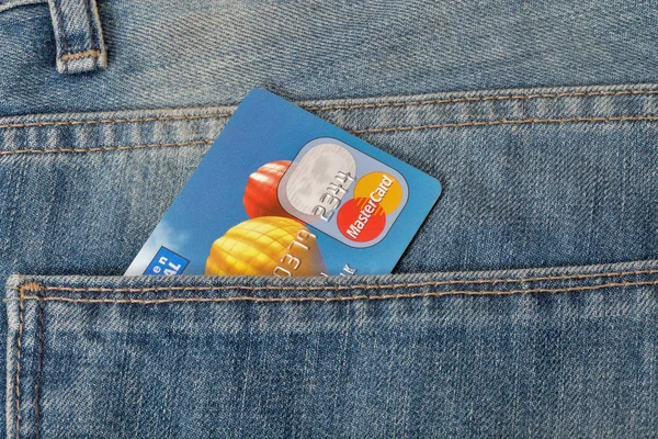 MasterCard credit card in pocket of blue jeans closeup — Stock Photo, Image