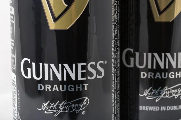 Guiness draught beer cans closeup against white — Stock Photo, Image