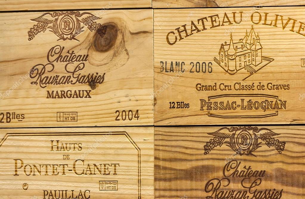 KIEV, UKRAINE - AUGUST 08, 2014: Corporate logo of the famous French winery Chateau Olivier and others on wooden wine boxes closeup. It is a Bordeaux wine from the Pessac-Leognan wine growing area.
