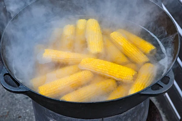 Street food boiled corn outdoors in metal pot closeup. — Stock Photo, Image
