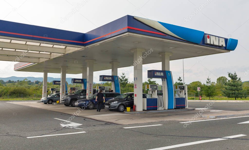 NOVI MAROF, CROATIA - SEPTEMBER 10, 2017: Unrecognized people refuel cars at INA gas station. INA is a medium sized European oil company, it has leading role in Croatian oil business.