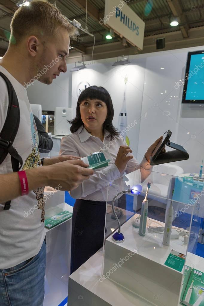 KIEV, UKRAINE - OCTOBER 07, 2017: People visit Philips Sonicare electric toothbrushes manufacturer booth during CEE 2017, the largest electronics trade show of Ukraine in KyivExpoPlaza EC.