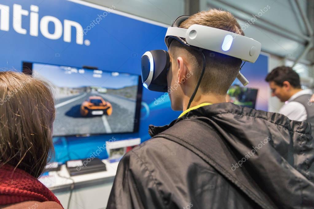 KIEV, UKRAINE - OCTOBER 07, 2017: People visit Sony PlayStation home video game console company booth during CEE 2017, the largest electronics trade show of Ukraine in ExpoPlaza Exhibition Center.
