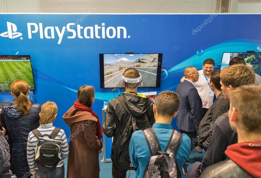 KIEV, UKRAINE - OCTOBER 07, 2017: People visit Sony PlayStation home video game console company booth during CEE 2017, the largest electronics trade show of Ukraine in ExpoPlaza Exhibition Center.