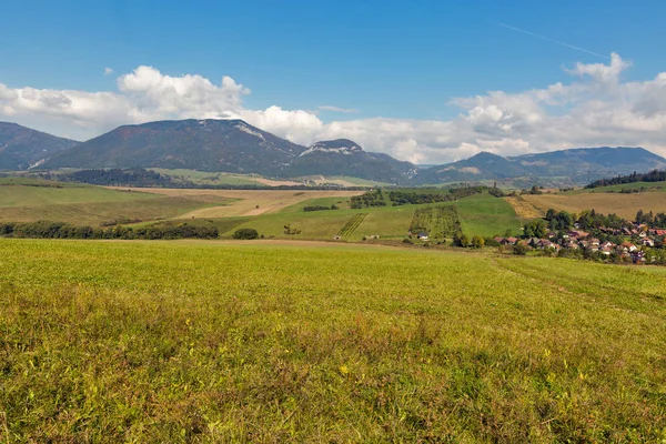 Letní kopce krajina s vesnicí Benusovce na Slovensku. — Stock fotografie