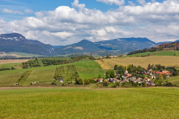 Letní kopce krajina s vesnicí Benusovce na Slovensku. — Stock fotografie