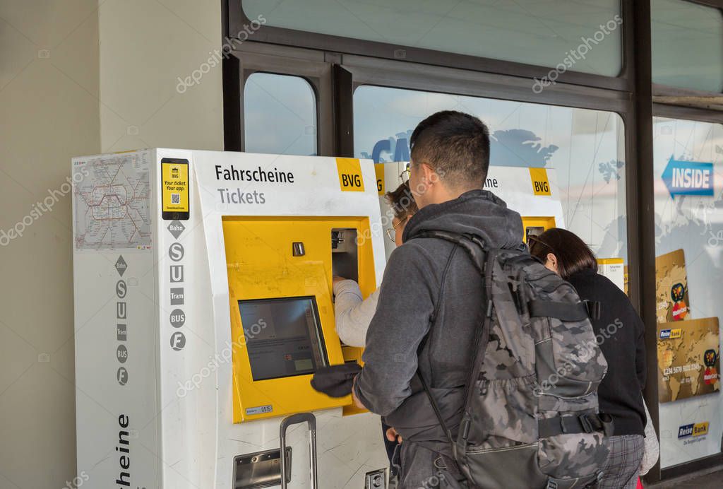 BERLIN, GERMANY - OCTOBER 18, 2019: Passengers buys a ticket in a special ticket vending machine in Tegel Otto Lilienthal airport. It is the main international airport of Berlin, the federal capital of Germany.