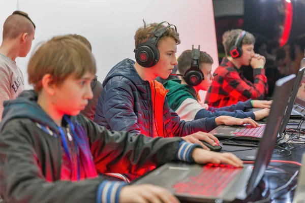 KYIV, UKRAINE - APRIL 13, 2019: Teens playing computers at game-centric Omen Hewlett-Packard brand of laptops and desktops at booth during CEE 2019, largest consumer electronics trade show of Ukraine