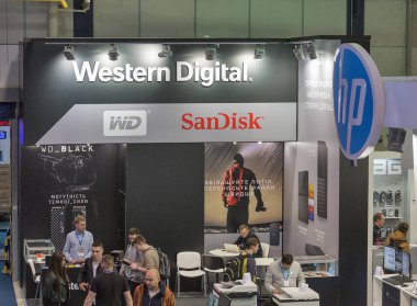 KYIV, UKRAINE - APRIL 13, 2019: People visit Western Digital, American computer data storage company booth during CEE 2019, the largest electronics trade show of Ukraine in Tetra Pack EC. clipart