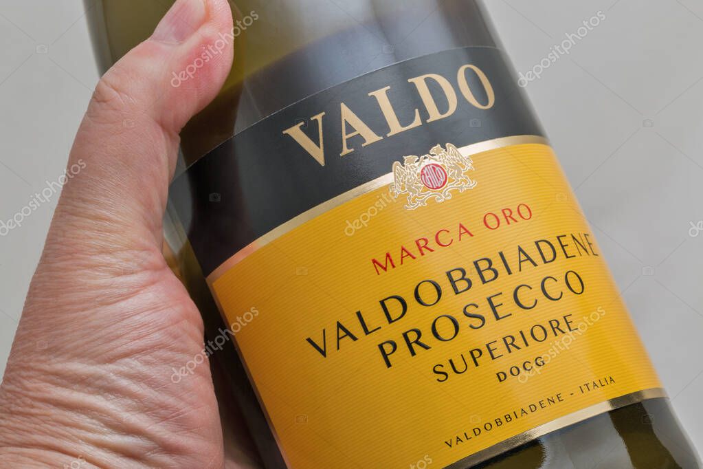 KYIV, UKRAINE - OCTOBER 27, 2019: Italian Marca Oro Valdobbiadene prosecco bottle closeup against white background. It is a white wine produced in area in Veneto and Friuli Venezia Giulia regions.
