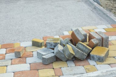 Laying Paving Slabs by mosaic close-up. Road Paving, constructio clipart