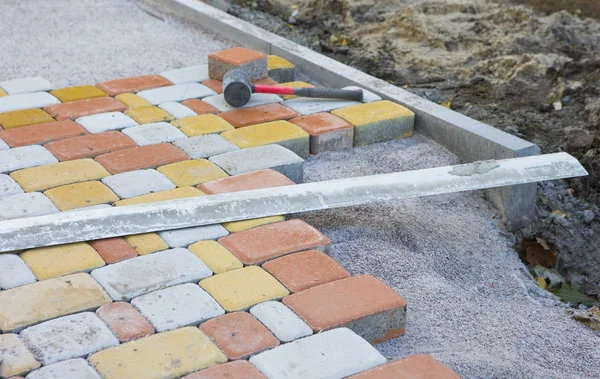 Laying Paving Slabs by mosaic close-up. Road Paving, constructio