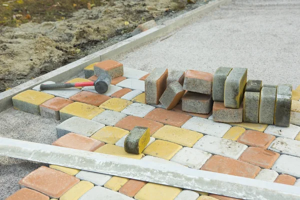 Laying Paving Slabs by mosaic close-up. Road Paving, constructio