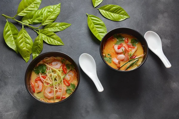 Laksa Soup  a Malaysian Coconut Curry Soup with shrimps over rice noodles topped with fresh bean spouts,cucumber, lime, red chili pepper and cilantro