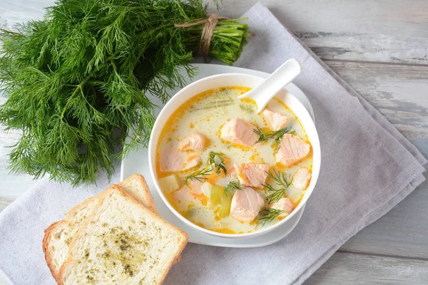 Creamy fish soup with salmon, potatoes, onions , carrots, dill and celery . Kalakeitto- traditional dish of the Finnish cuisine or Russian Ukha Fish Head Soup. Healthy Food Concept. Omega -3