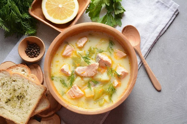 Creamy fish soup with salmon, potatoes, onions , carrots, dill and celery . Kalakeitto- traditional dish of the Finnish cuisine or Russian Ukha Fish Head Soup. Healthy Food Concept. Omega -3