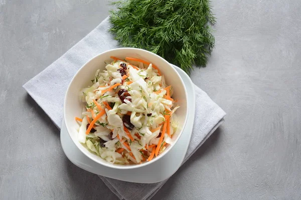 Cabbage salad with carrot, smoked almonds and dried cranberries. Coleslaw Salad.Fermented cabbage- Russian cuisine. Healthy vegan food concept.