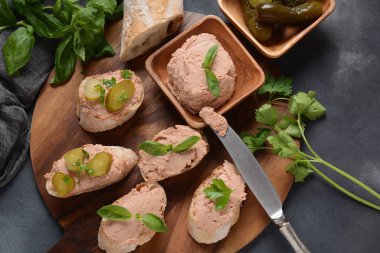 Chicken or goose liver pate sandwiches on a wooden board