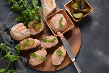 Chicken or goose liver pate sandwiches on a wooden board