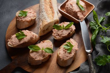 Chicken or goose liver pate sandwiches on a wooden board